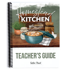 A spiral-bound book titled "Homestead Kitchen Teacher's Guide" with an illustrated cover showing a teal pot of bread on a wooden table, herbs, jars, and kitchen items against a white background.