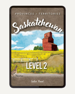 A digital workbook cover titled "Saskatchewan" with "Provinces + Territories" at the top and "Level 2" near the bottom. The artwork shows a rural Saskatchewan landscape with a red-brown grain elevator, yellow field, blue sky, white clouds, and a dirt road.