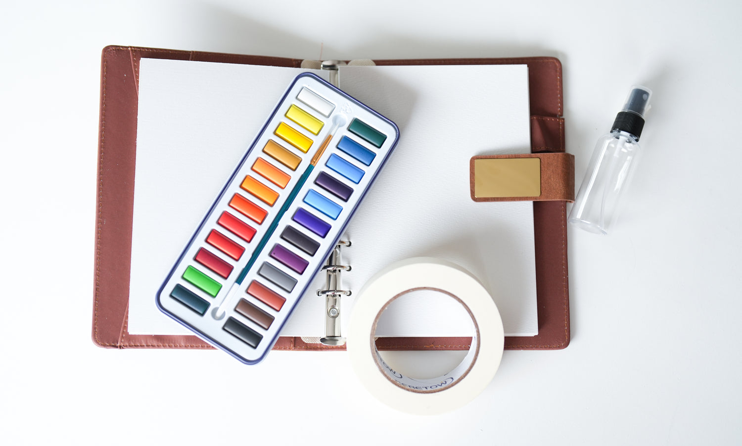 Ocean Life homeschool unit study watercolor kit with tape, paints, and leather notebook with white paint paper inside 