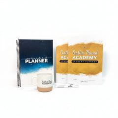 Gather 'Round Academy welcome kit with Surrender planner and two Student Planner for homeschool with a Gather 'Round Academy coffee cup and two pens 